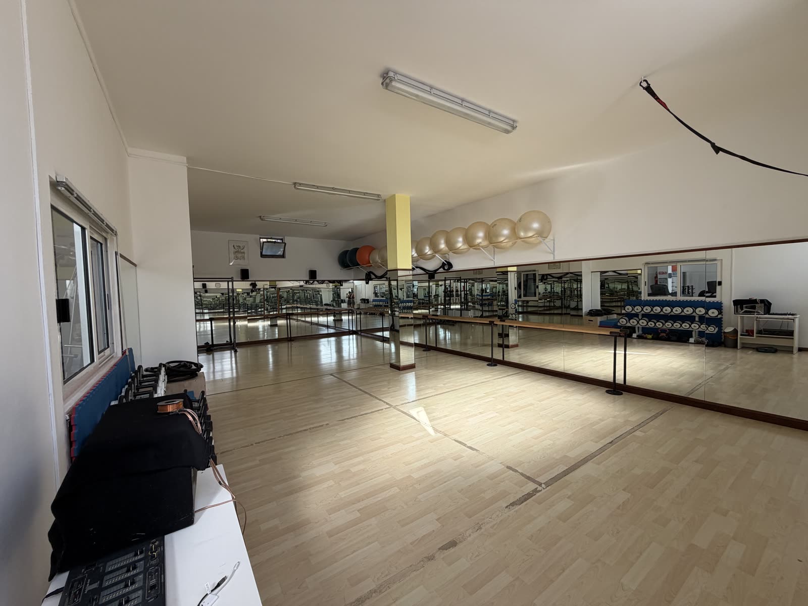 Sala corsi AstraFit vista d'insieme: parquet, specchi e fitball